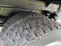 A close-up view of a Hino 195 tire showing its tread pattern with visible wear and dirt on the surface