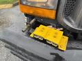 A yellow mounting bracket with two rectangular connectors attached to the front of a 2000 Ford F-450 truck