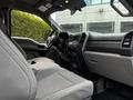 Interior view of a 2017 Ford F-250 featuring gray cloth seats a steering wheel and dashboard with control buttons and touchscreen display