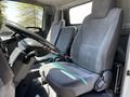 Interior of a 2007 GMC W3500 featuring two gray cloth seats and a steering wheel visible in the foreground