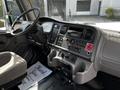 Interior dashboard of a 2012 Freightliner M2 106 featuring controls gauges and a stereo system with a plush driver seat and a floor mat that says Thank You