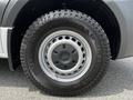 Close-up of the tire and wheel of a 2019 Mercedes-Benz Sprinter featuring a silver wheel cover and rugged Kumho tire