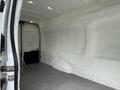 Interior view of a 2017 Ford Transit van showing a spacious cargo area with white insulated walls and a metal floor