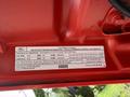 A 2013 Ford F-550 vehicle emission control information label detailing engine specifications and fuel capacity