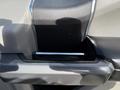 Close-up of the interior door handle of a 2018 Ford F-150 featuring a sleek design with a chrome accent and a textured surface
