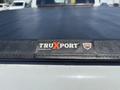 A 1995 Ford F-250 with a black truck bed cover featuring a TRUXPORT logo from Truxedo Truck Accessories