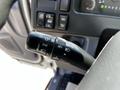 Close-up of the turn signal lever and control stalk inside a 2007 GMC W3500 showing various settings for lights and indicators