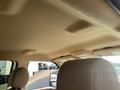 The interior roof of a 2014 Ford F-350 SD showing a beige fabric covering with overhead handles and light controls above the driver and passenger seats