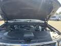 A 2016 Chevrolet Tahoe with its hood open revealing the engine compartment and various mechanical components inside