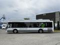 A 2018 Grande West Vicinity bus with a white body displaying green logo and text about its features powered by compressed natural gas