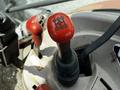 Close-up of a Kubota M8540D tractor gear stick with a bright red handle featuring six gear shift patterns