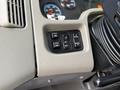 Control panel of a 2011 International WorkStar featuring buttons for mirror adjustment and panel light settings