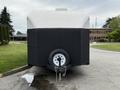 A black and white 2025 Shuttle Office trailer with a single wheel and a hitch at the front