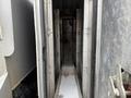 A detailed view of the interior of a 2011 Dodge Ram 5500 revealing a narrow, elongated compartment with metal walls and a white base