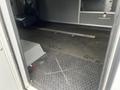 Interior of a 2016 Chevrolet Express van featuring a textured floor with evidence of use and a ramp extending into the cargo area