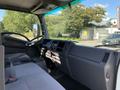 Interior view of a 2015 Isuzu NPR showing the driver's seat dashboard and steering wheel