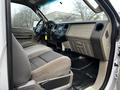 Interior view of a 2009 Ford F-550 showing the front seats dashboard and controls with a spacious layout and fabric upholstery