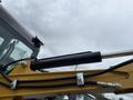 Close-up of the hydraulic arm of a 2024 AGT Industrial Yellow H13R Mini Excavator showcasing the hydraulic cylinder and attachment points