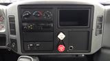 The interior dashboard of a 2005 International 4300 featuring gauges switches and a central console with a radio and storage compartments