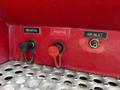 Close-up of a panel on a 2009 Spartan Gladiator showing three labeled ports for negative and positive connections and an air inlet
