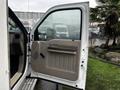 A 2009 Ford F-550 with an open door showcasing the interior features and door panel design