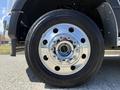 Close-up of a chrome wheel rim on a 2023 Ford F-550 featuring a black tire with visible tread patterns and lug nut design