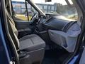 Interior view of a 2017 Ford Transit showcasing the driver's seat and dashboard with controls and a touchscreen display