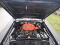 The image shows a 1974 Dodge Challenger with its hood raised revealing the engine compartment featuring a bright red air cleaner and various engine components
