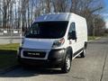 A white 2021 RAM Promaster van is parked with the front view visible showing the grille and headlights