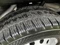 Close-up of the tread on a tire from a 2023 Ford Transit showing deep grooves and textured surface for traction