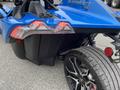 A blue 2020 Polaris Slingshot showing its rear tail lights distinctive design and tires