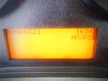 Close-up of a digital display showing the hours of operation as 1634 on a vehicle dashboard