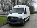 A 2021 Mercedes-Benz Sprinter van with a white exterior and black grille parked on a paved area