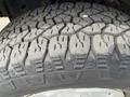Close-up of a rugged tire tread on a 2009 Ford Econoline showing deep grooves and detailed patterns designed for traction and durability