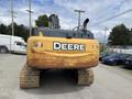 A 2018 John Deere 350 excavator featuring a large yellow body and a distinctive logo with the word Deere on the rear side