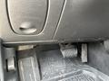 Interior view of a 2005 Chrysler PT Cruiser showing the footwell with a rubber floor mat and gas and brake pedals