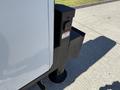 A 2023 Ford F-550 with a black mounting bracket and a warning label attached to the side