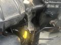 Close-up view of a 2004 Ford Econoline engine with visible components including hoses and a yellow cap