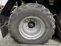 Close-up of a large agricultural tire from a 2020 Pottinger Impress with a ribbed tread pattern and visible rim bolts