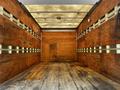 Interior view of a 2007 GMC W3500 truck with a wooden cargo area featuring wooden paneling and a flat wooden floor
