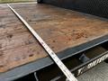 2020 Ford F-350 with a wooden bed and a measuring tape laid across the surface