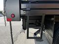 A close-up view of a black truck's rear step and hitch area from a 2021 Ford F-550