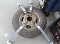 A 2020 Chevrolet Express tire secured by four gray ratchet straps