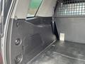 Interior view of a 2016 Chevrolet Tahoe cargo area showing side panel and partition with a textured metal grid