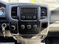 Dashboard of a 2019 RAM 1500 Classic featuring a central infotainment unit with knobs for climate control and audio settings along with gear selector and ignition key