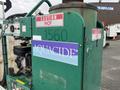 A green 2011 Hightliner Aquacide Hot Water Weed Control Dual Flat Deck Trailer with a visible Aquacide logo and caution signs indicating hot surfaces
