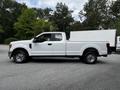 A 2017 Ford F-250 white pickup truck with a single cab and bed in profile view