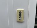 A keypad with numbered buttons from 1 to 9 mounted on a surface