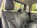 Interior view of a 2018 RAM 1500 showing the black leather back seat with headrests and seat belts