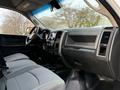 Interior view of a 2013 RAM 3500 featuring gray fabric seats a dashboard with touchscreen controls and a black console area